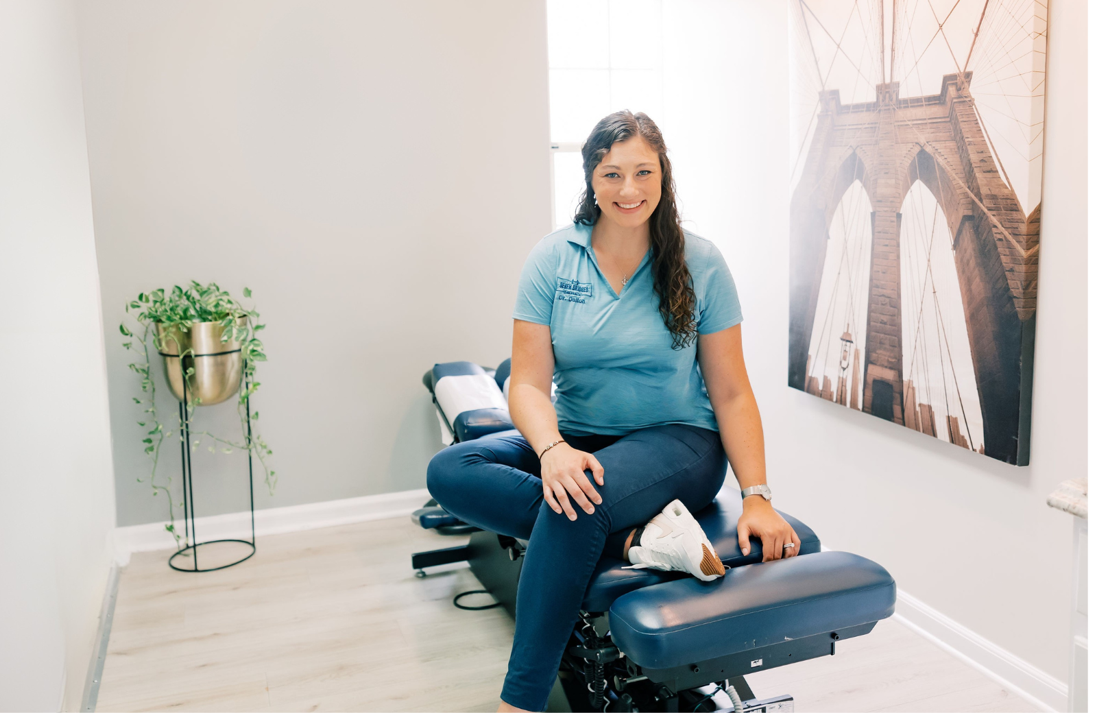 Dr. Dalton Tolliver sitting on adjusting table at Seven Bridges Chiropractic Jacksonville Fl