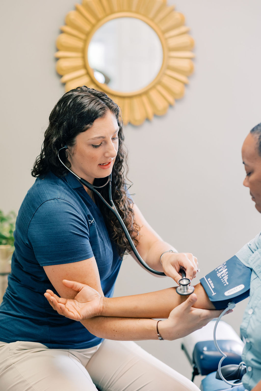 Dr. Dalton getting vitals for a new patient as they focus on treating her conditions to get her back to feeling good!