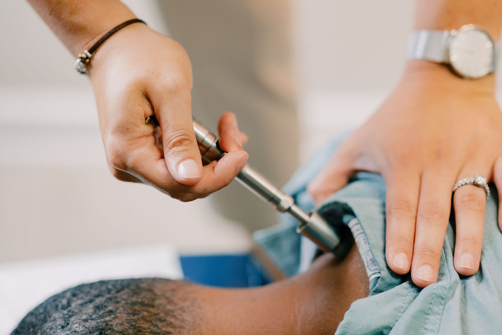 Chiropractic care in Jacksonville, FL using an IASTM adjustment tool to assist with neck pain