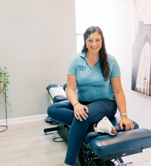 Dr. Dalton Tolliver sitting on adjusting table at Seven Bridges Chiropractic Jacksonville Fl