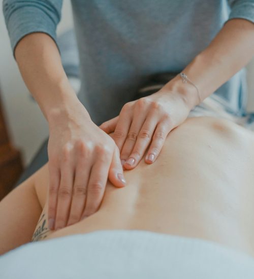 close up on hands massaging back